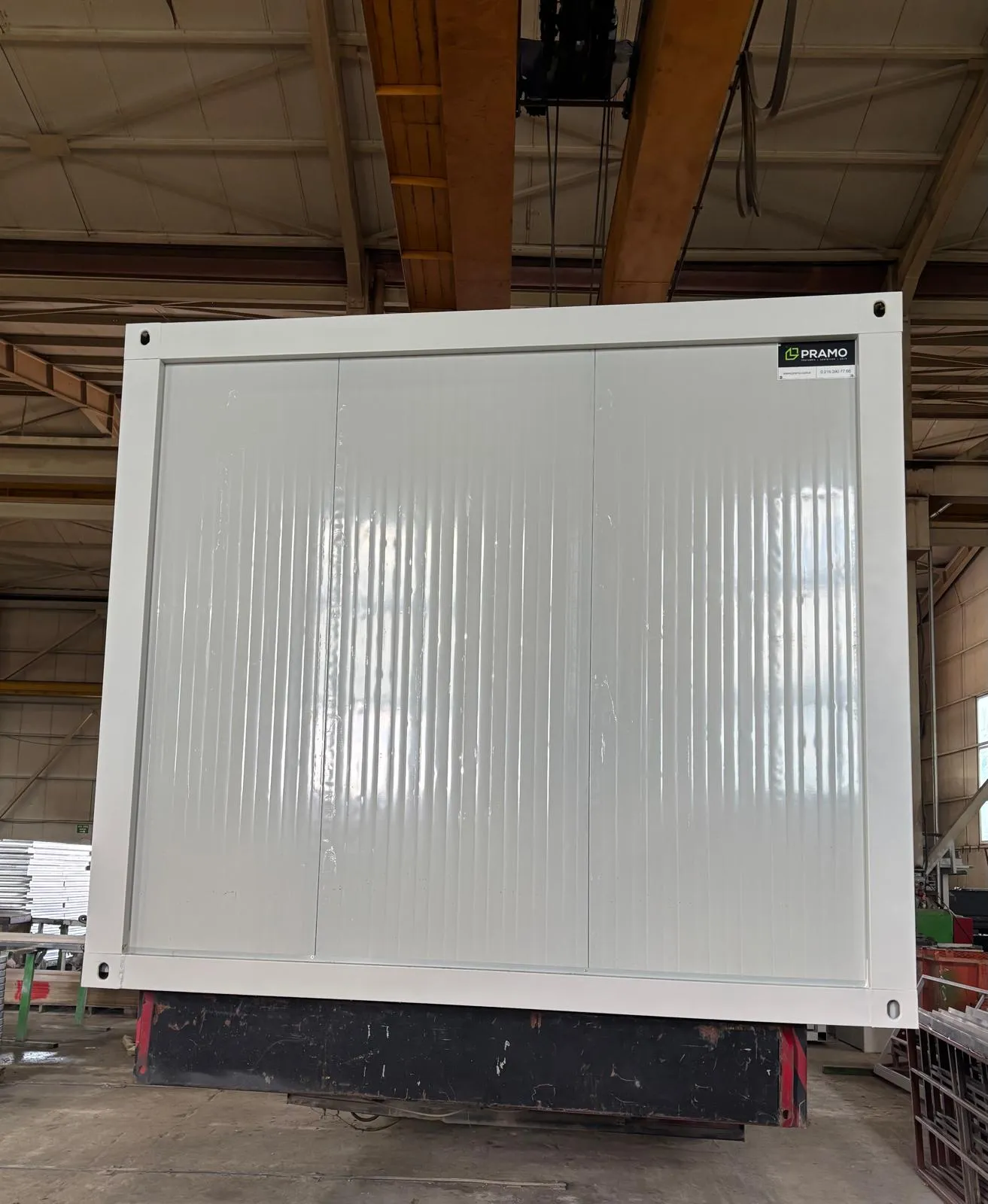 Efficient production line for flat pack house assembly services inside industrial facility.